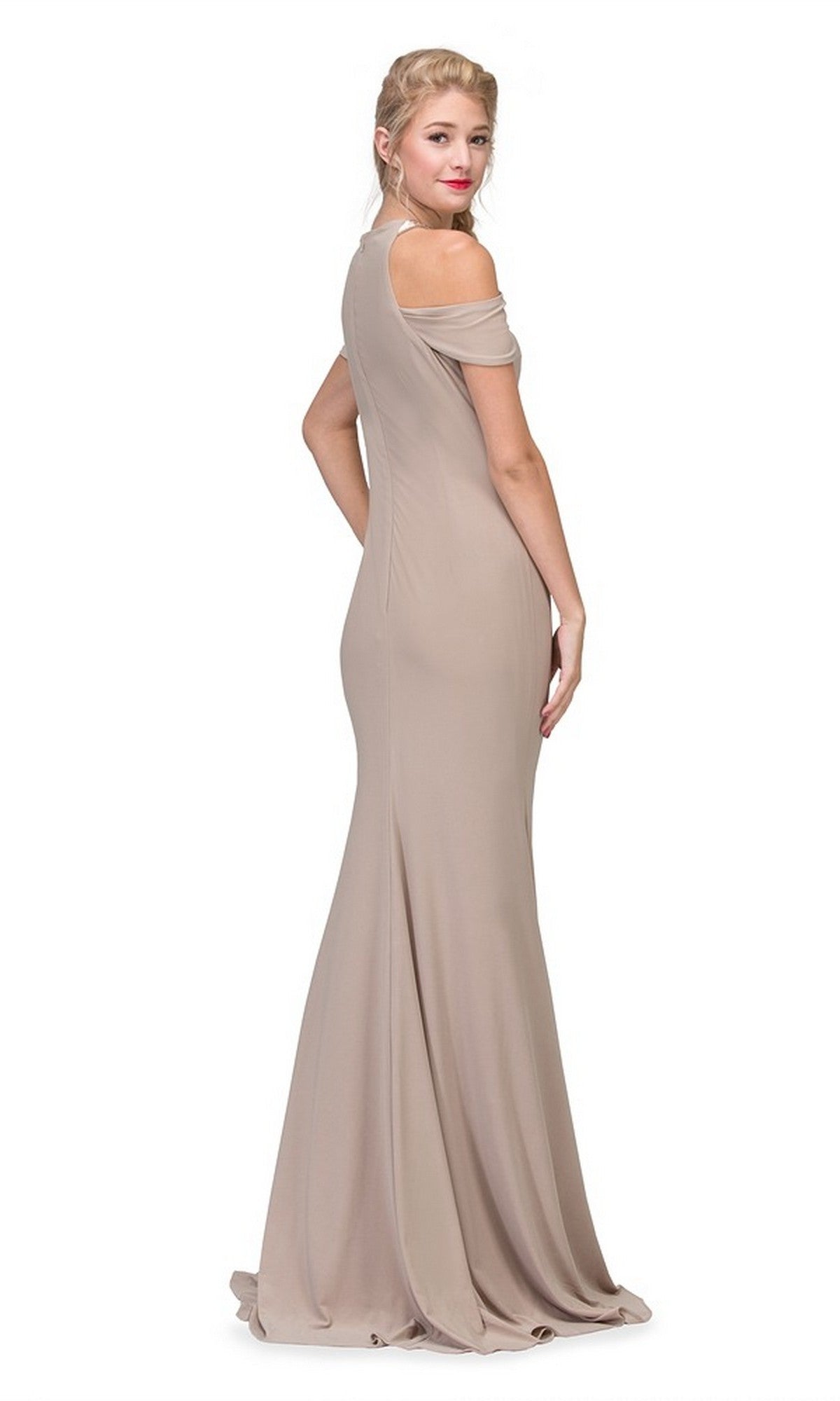 A woman poses facing away from the camera, glancing back over her shoulder in the Eureka 7400 long formal dress with a cold shoulder neckline and floor-length taupe design, set against a white background.